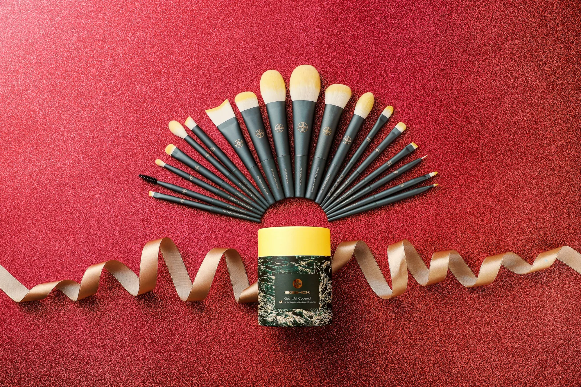 a group of makeup brushes sitting on top of a red carpet
