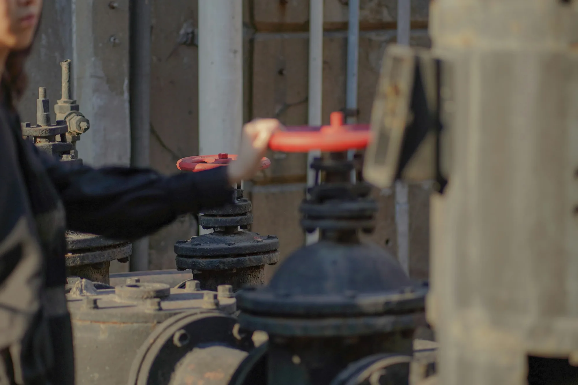 person holding red and black metal tool