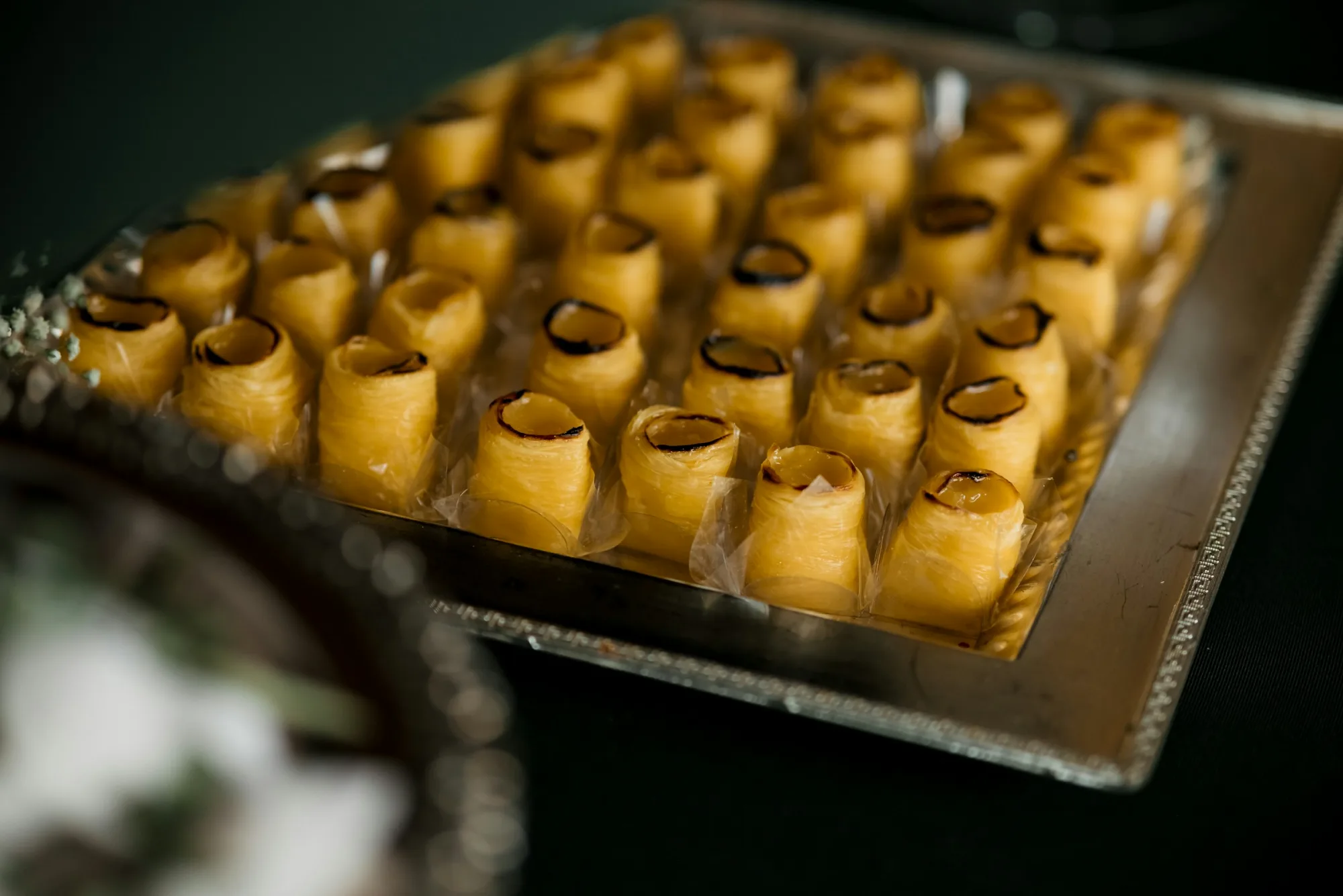 Tray of golden pastries arranged neatly